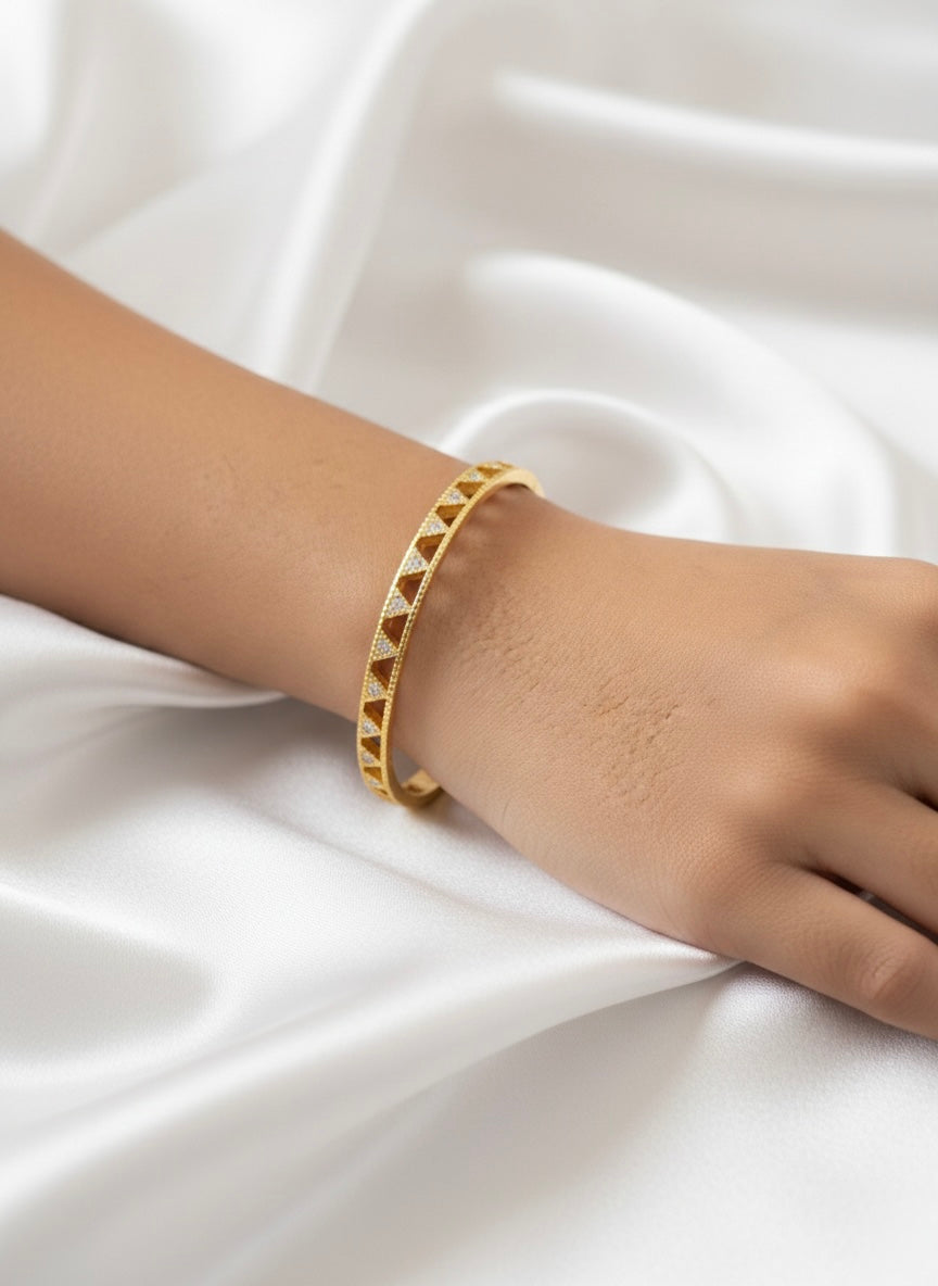 Elegant gold bangle with geometric sparkle