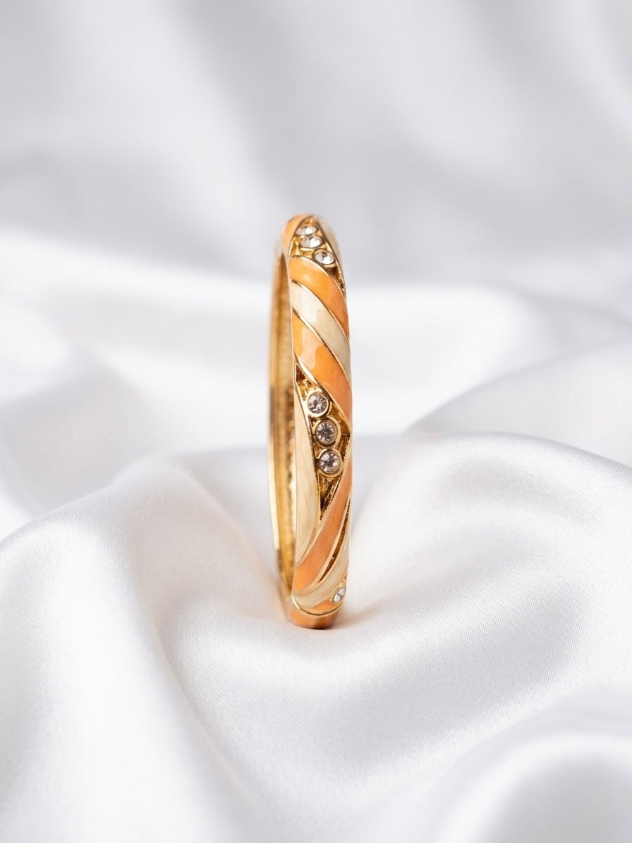 Elegant gold-tone enamel bangle with stones