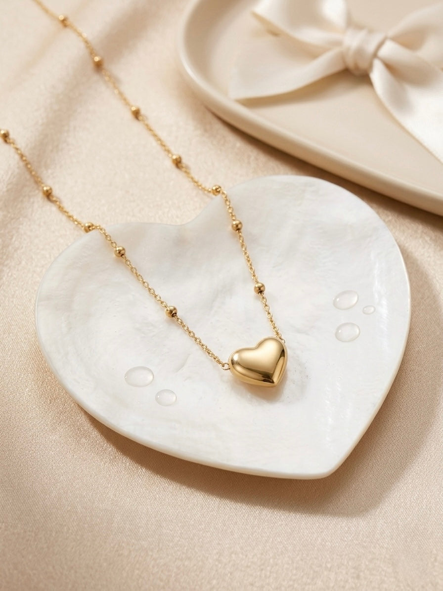 Minimalist gold puffed heart pendant.