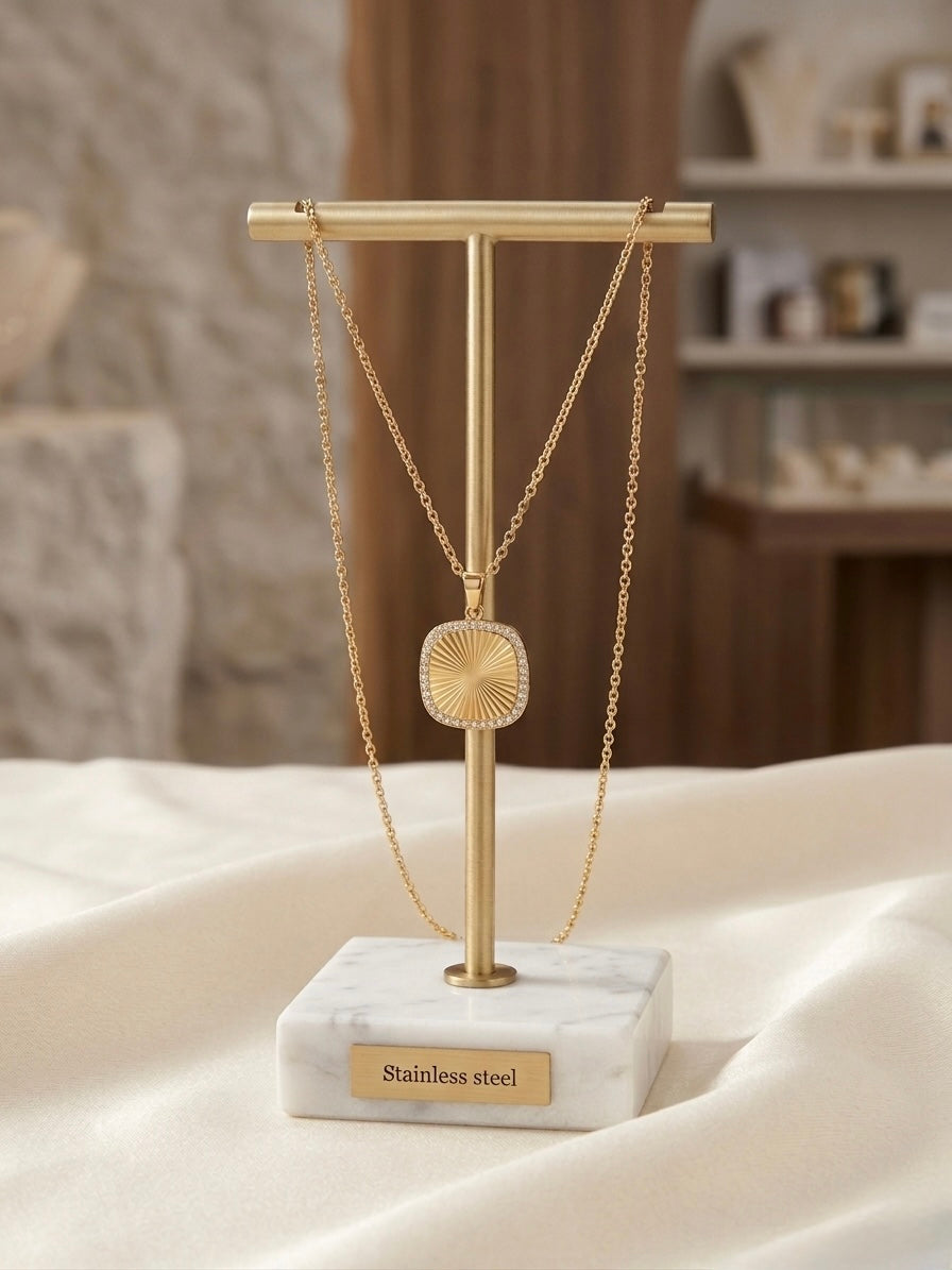 Elegant gold stainless steel sunburst necklace.