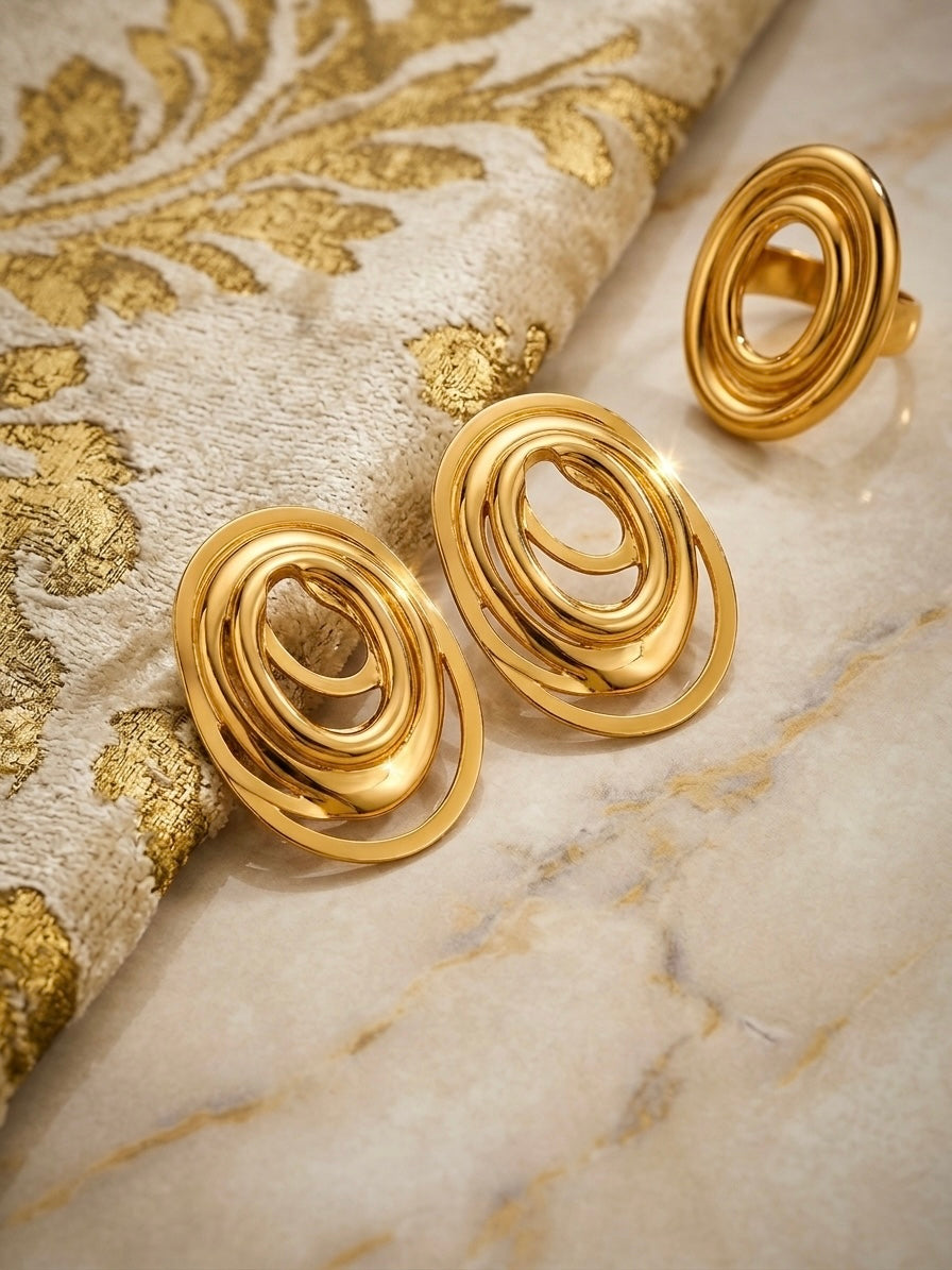 Elegant gold swirl ring and earrings.