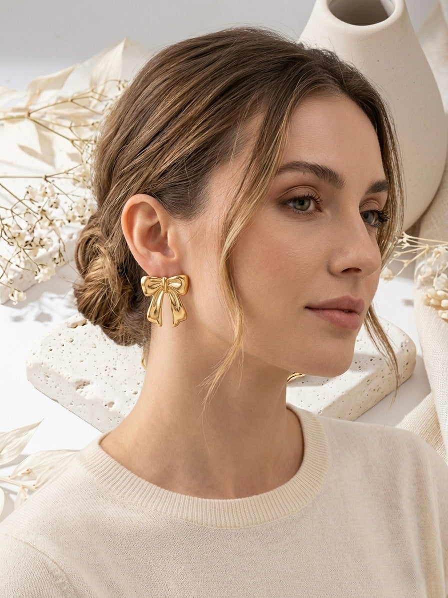 Charming gold bow stud statement earrings.