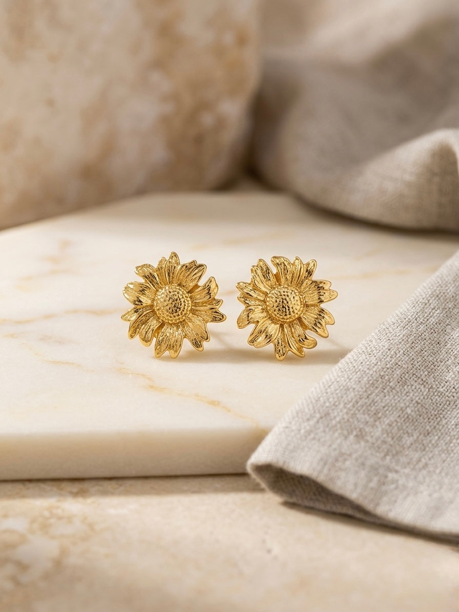 Intricate textured gold sunflower stud earrings.