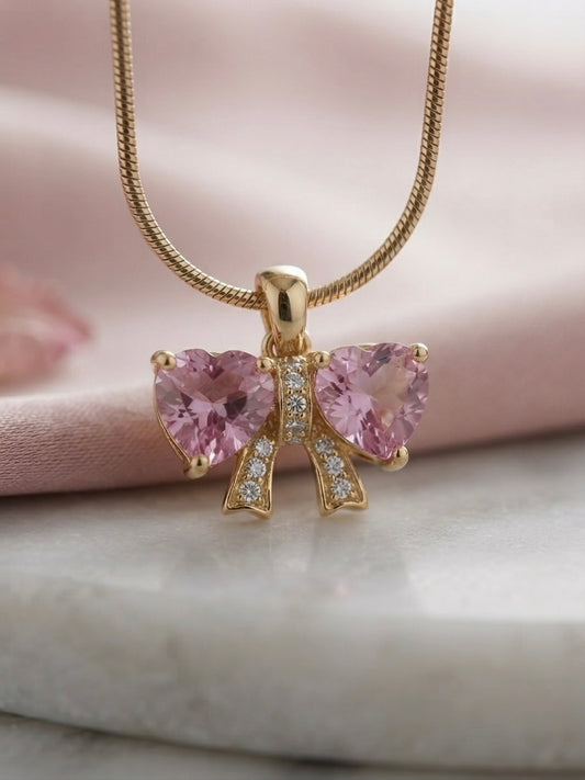 Elegant gold bow heart necklace.
