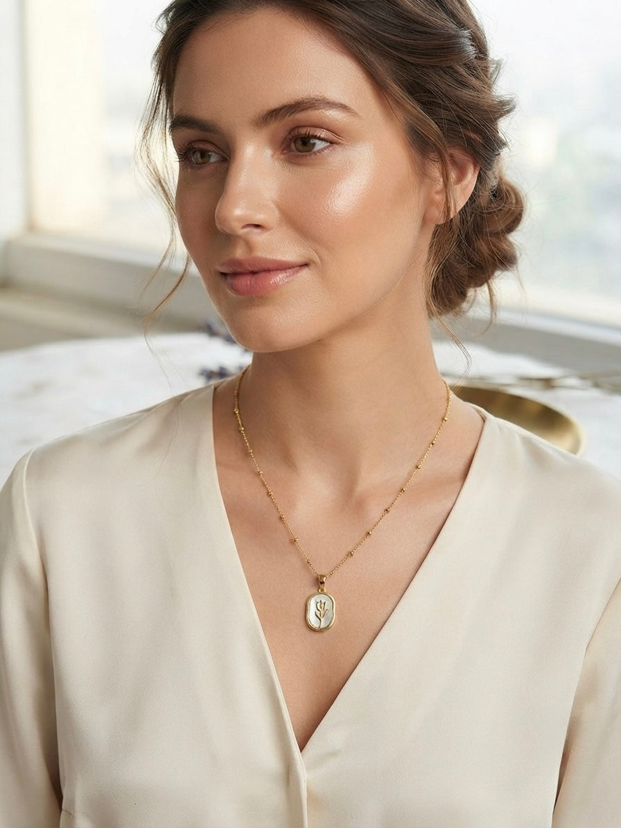 Elegant gold tulip pendant necklace.