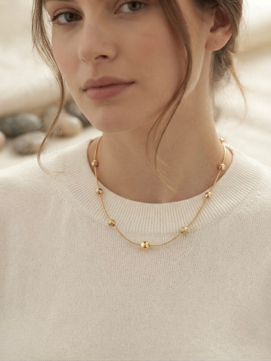 Minimalist gold beads, timeless refined style.