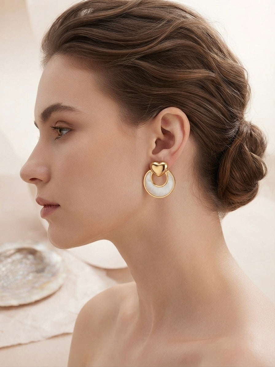 Gold heart and mother-of-pearl earrings.