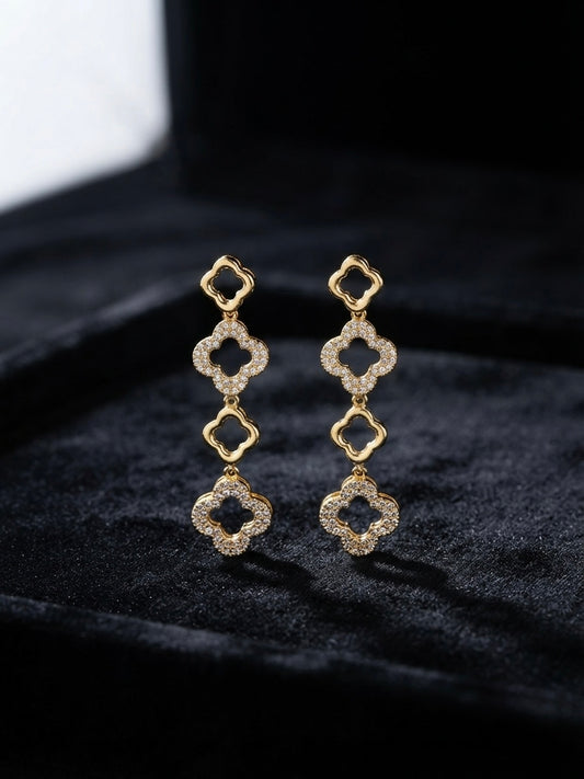 Alternating crystal and gold clover dangles.