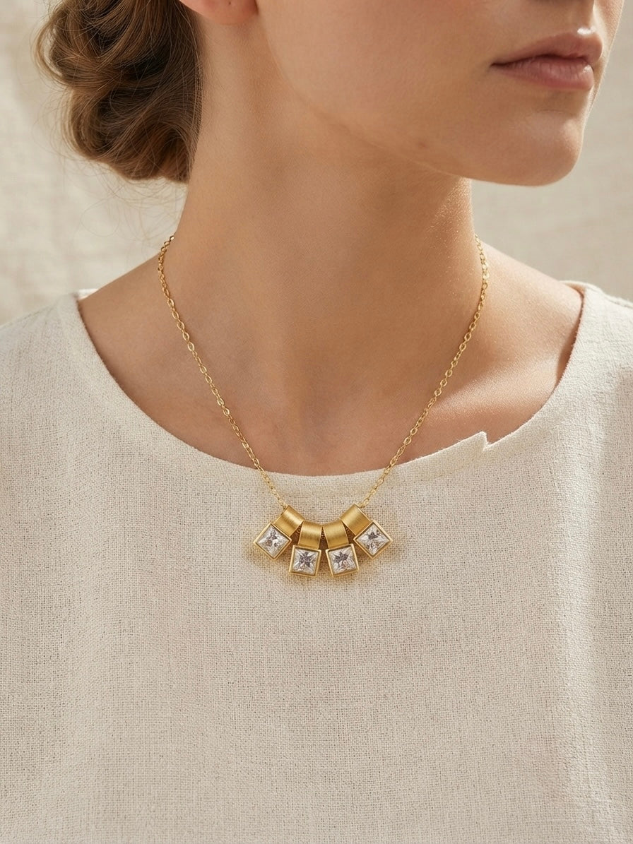 Gold four crystal square charm slider necklace.
