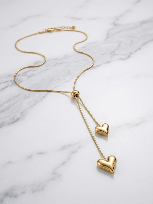 Adjustable chain double heart lariat necklace.