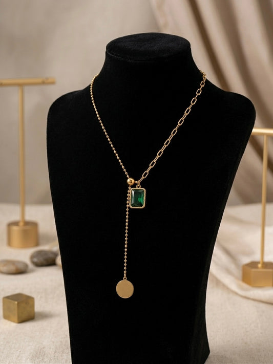 Gold dual-chain necklace with emerald drop.