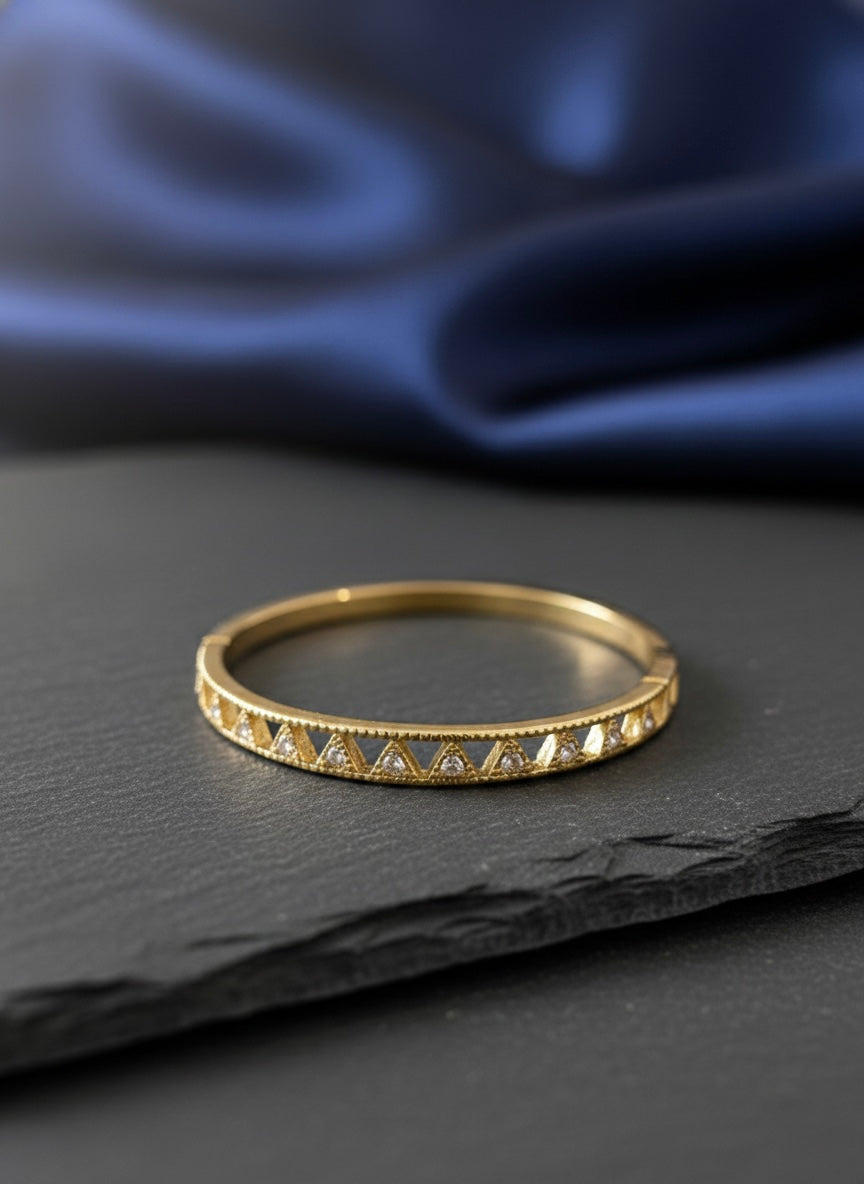 Elegant gold bangle with geometric sparkle