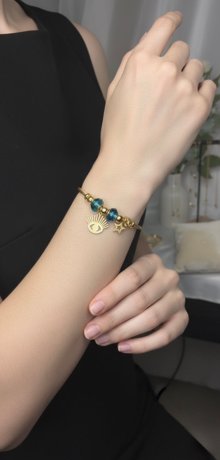 Elegant gold charm bracelet with eye