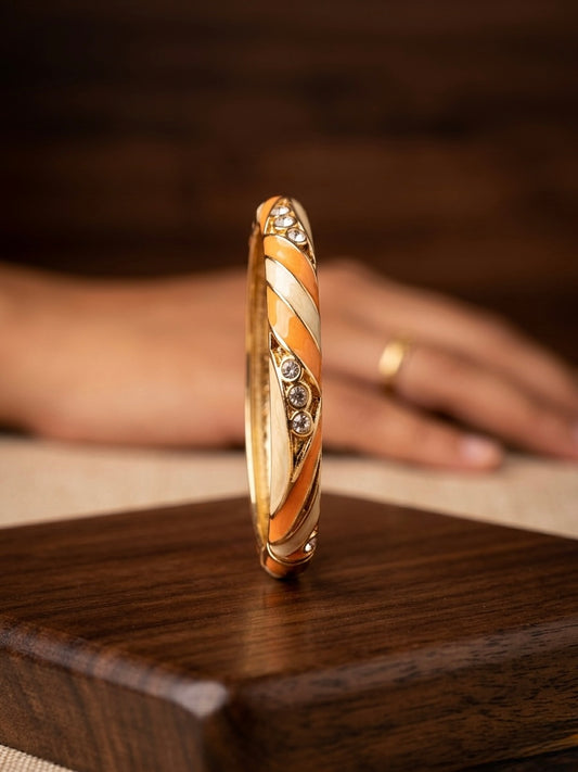 Elegant gold-tone enamel bangle with stones