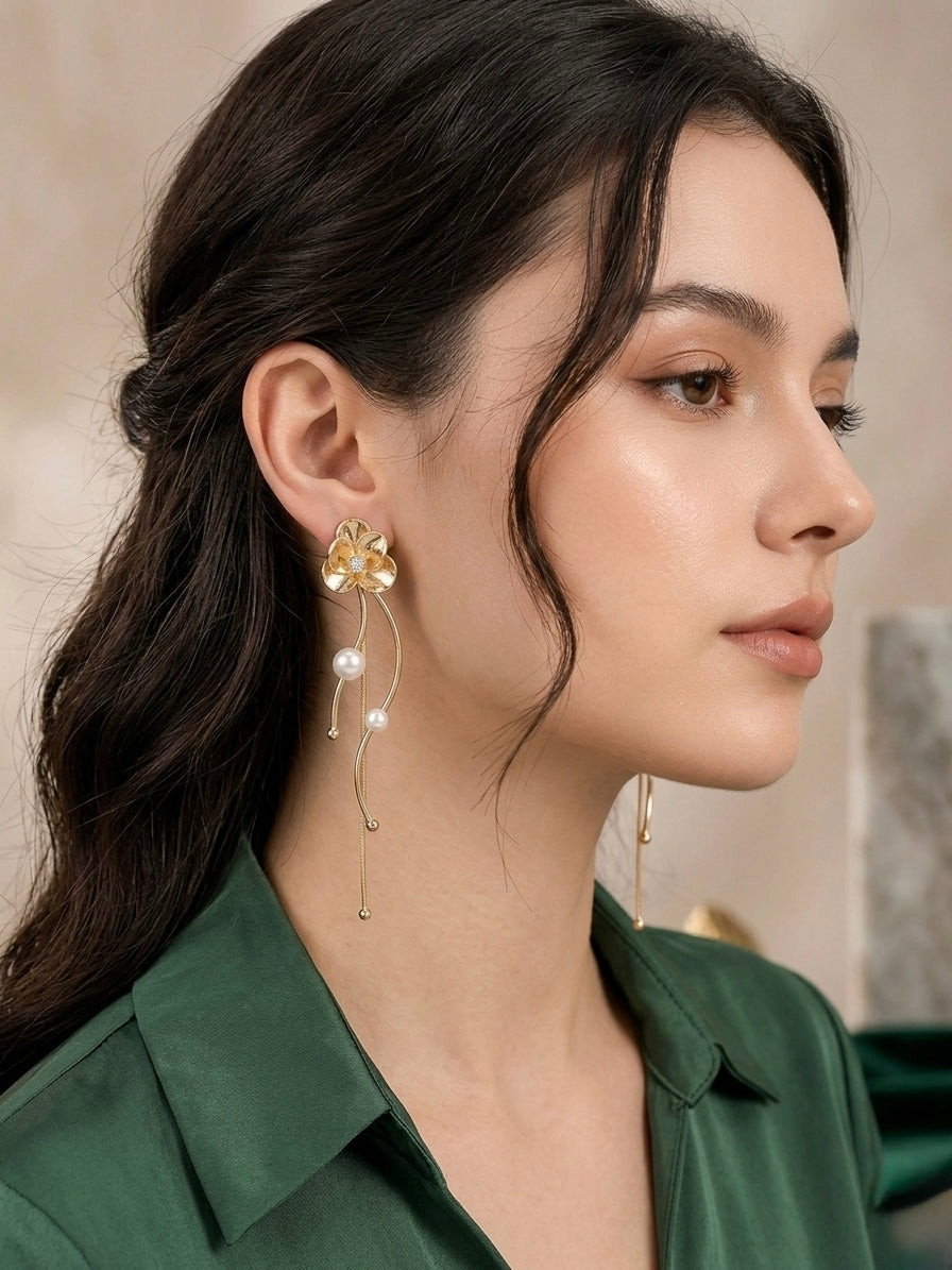 Elegant gold floral drop pearl earrings.