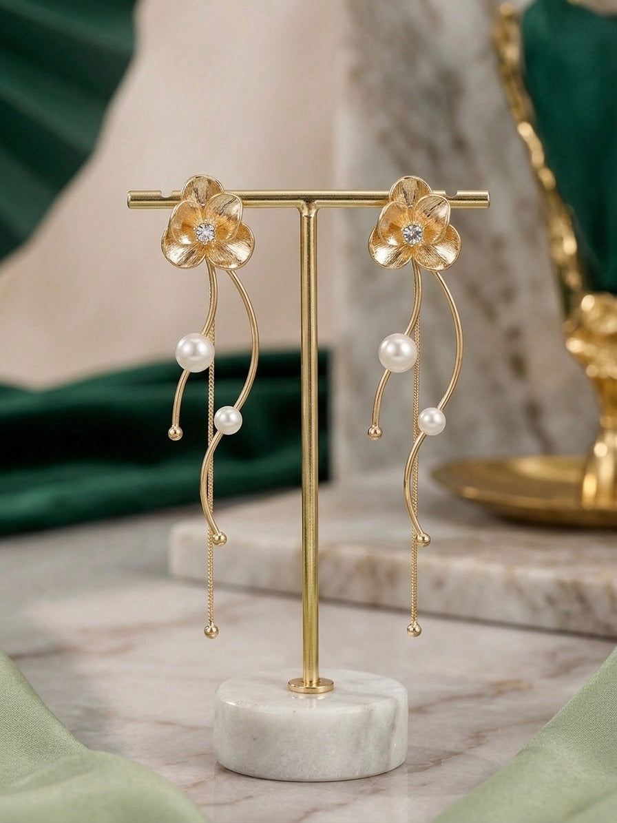 Elegant gold floral drop pearl earrings.