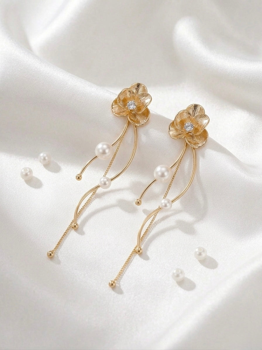 Elegant gold floral drop pearl earrings.