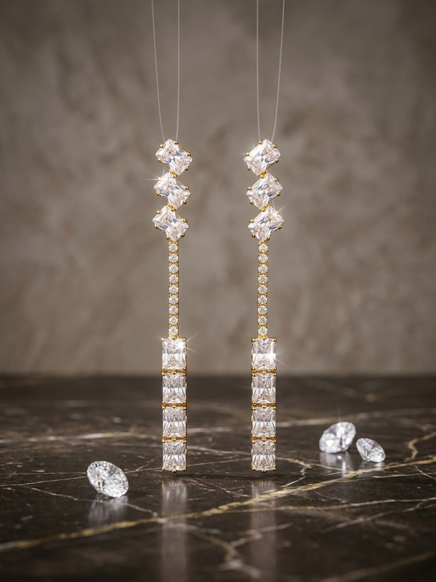 Luxurious gold geometric diamond drop earrings.