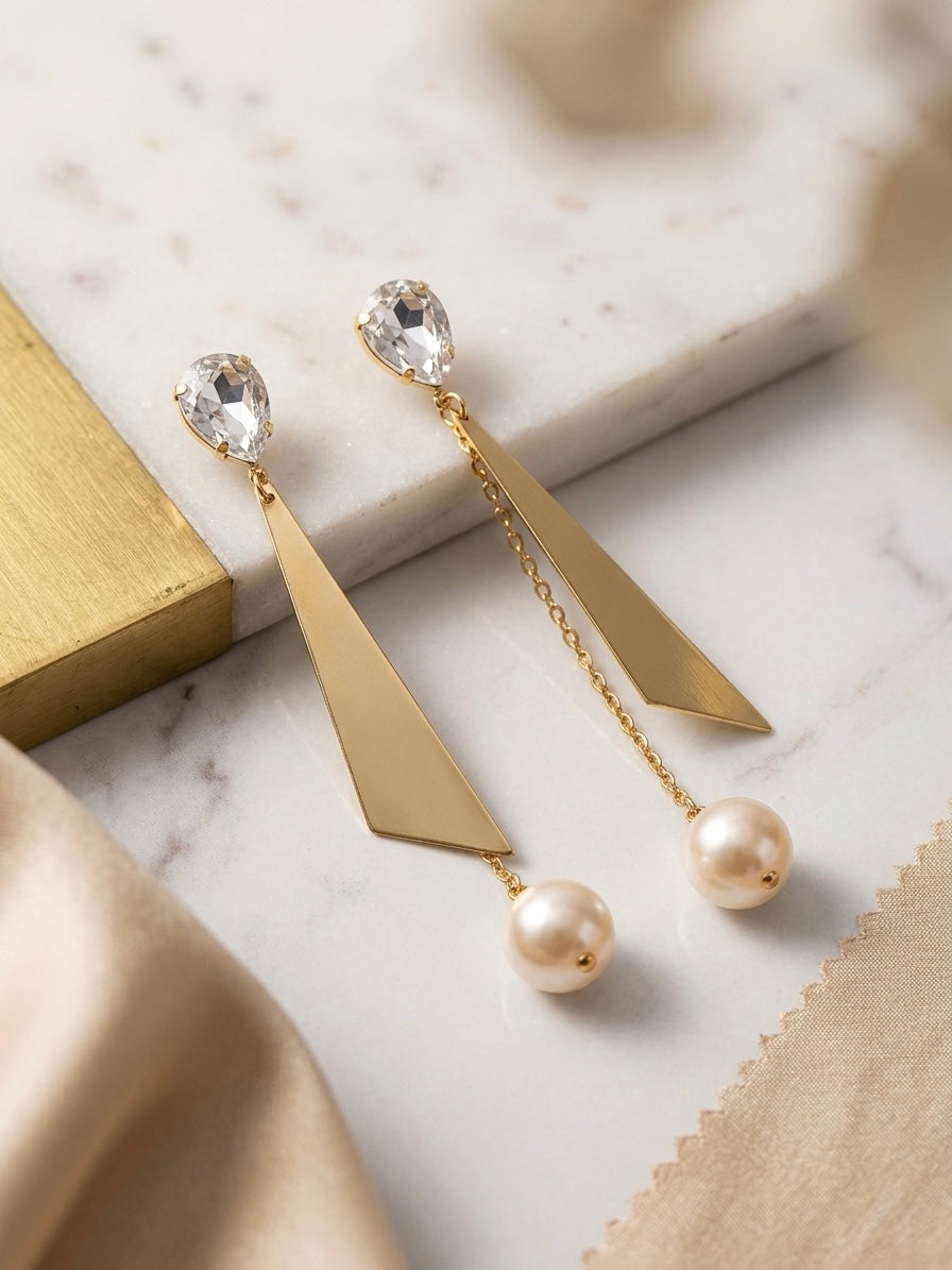 Contemporary gold geometric crystal pearl earrings.
