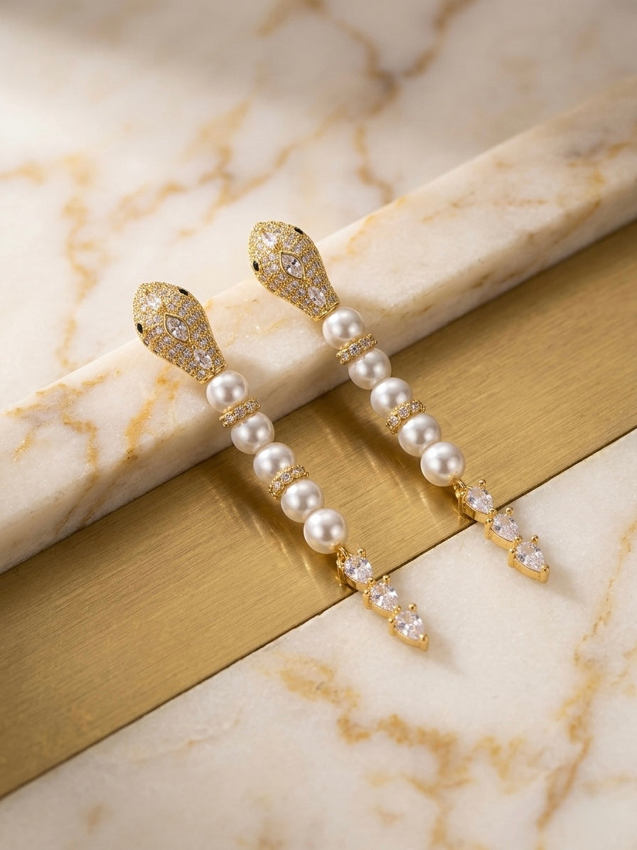 Luxury gold snake pearl drop earrings.