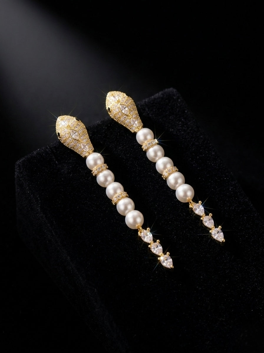 Luxury gold snake pearl drop earrings.