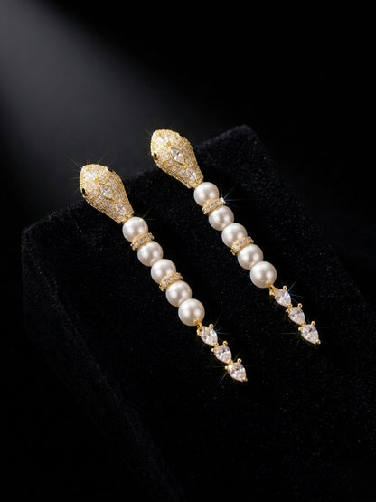 Luxury gold snake pearl drop earrings.