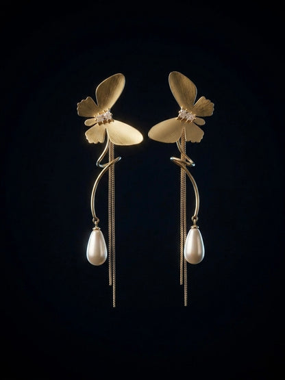 Statement gold butterfly long tassel earrings.