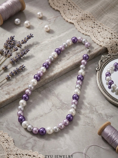 Elegant dark purple pearl strand necklace.