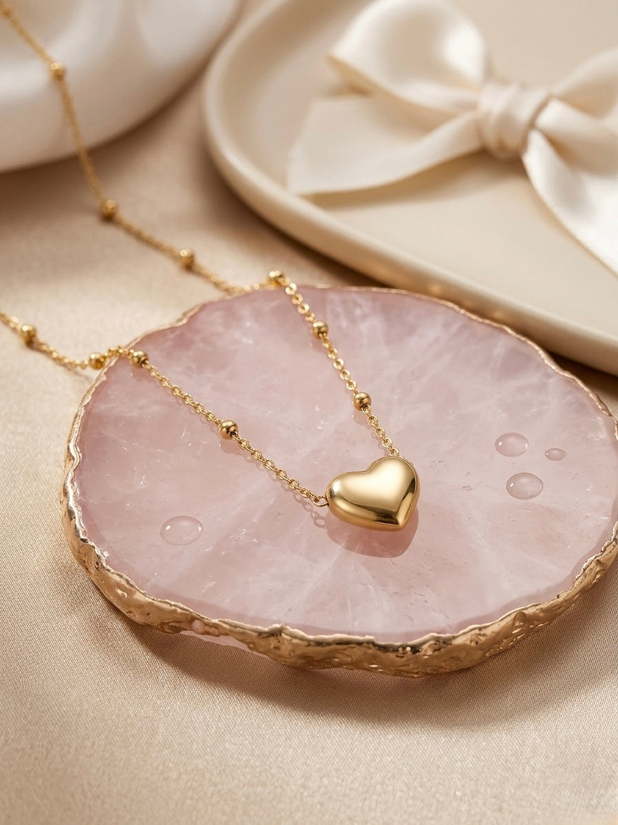 Minimalist gold puffed heart pendant.
