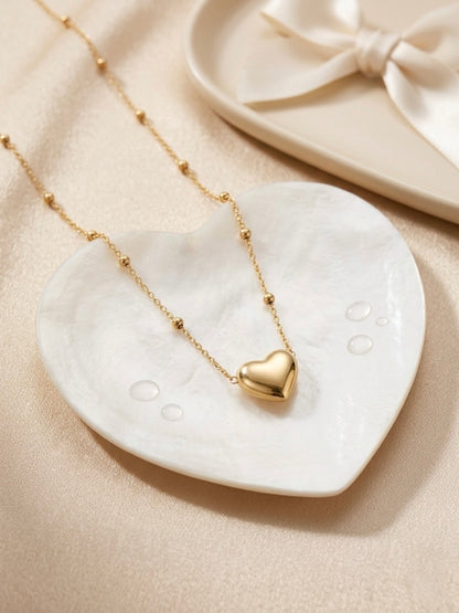 Minimalist gold puffed heart pendant.