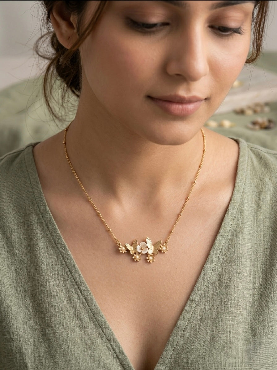 Charming gold butterfly flower satellite necklace.