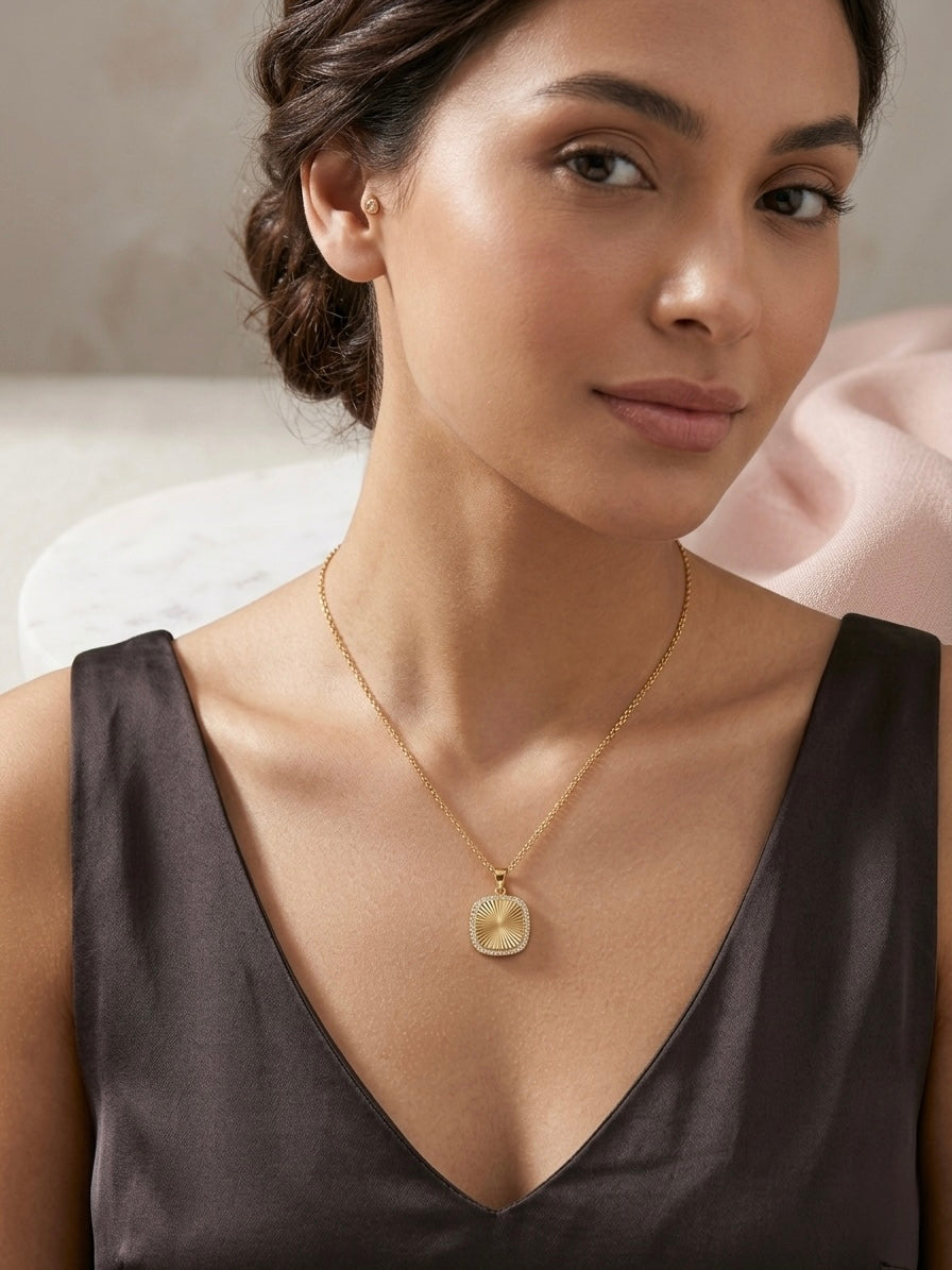 Elegant gold stainless steel sunburst necklace.