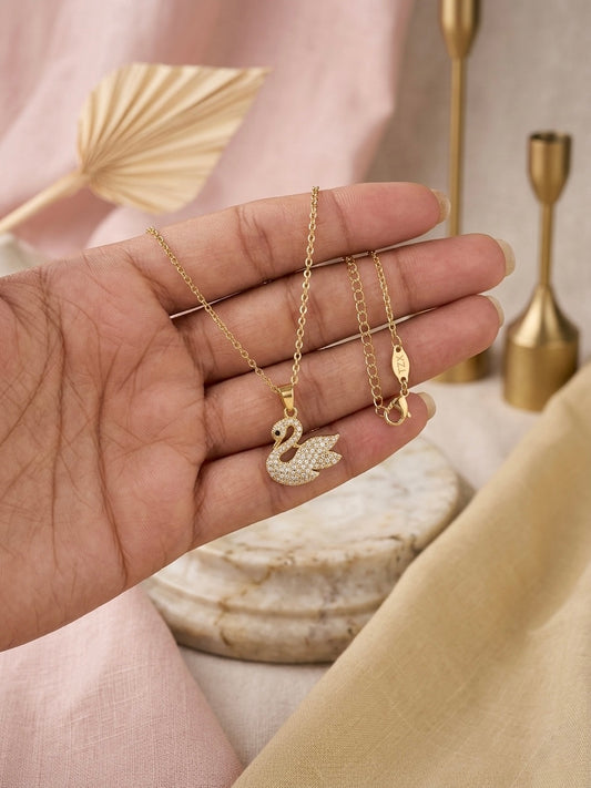 Elegant crystal-embellished gold swan necklace.