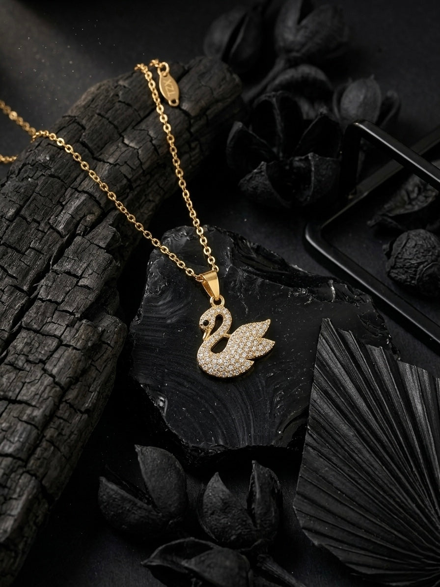 Elegant crystal-embellished gold swan necklace.