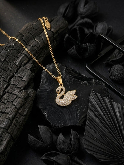 Elegant crystal-embellished gold swan necklace.