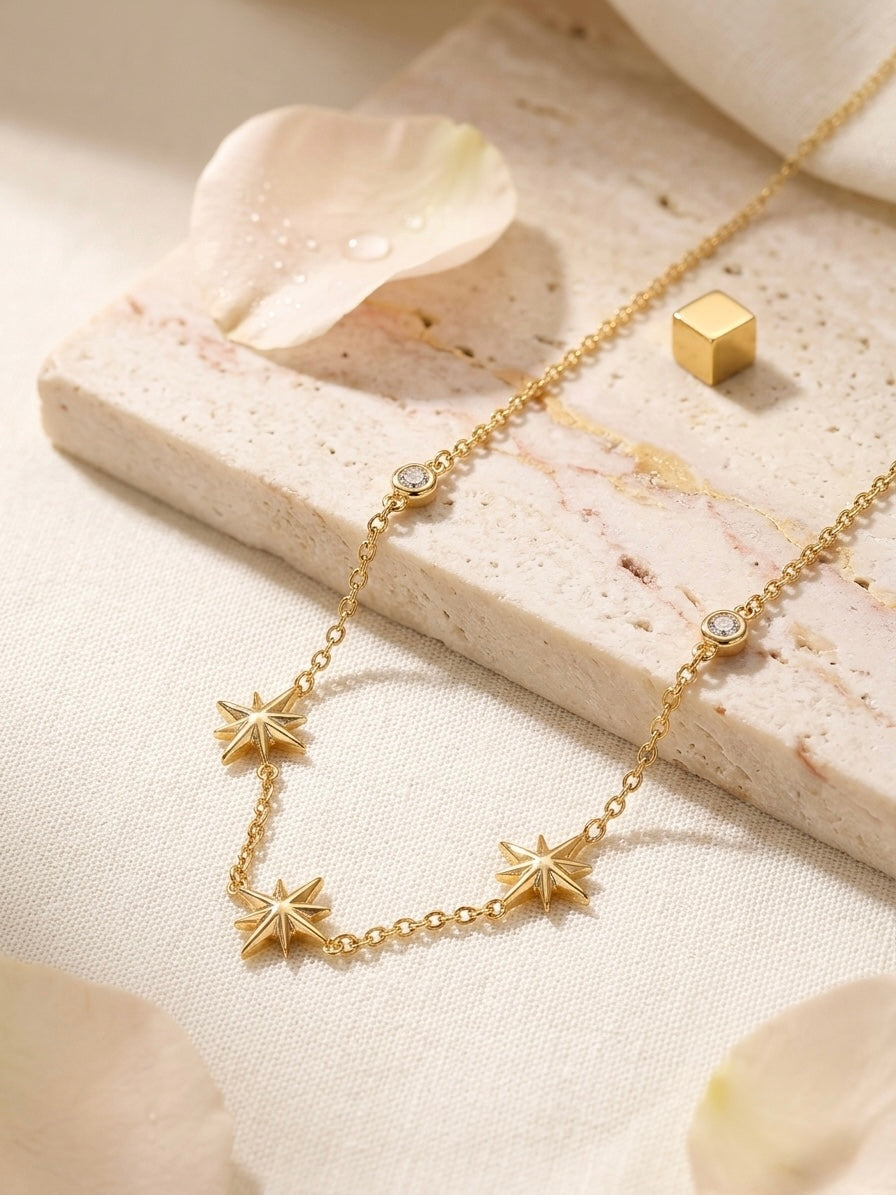 Delicate gold multi-star charm necklace.
