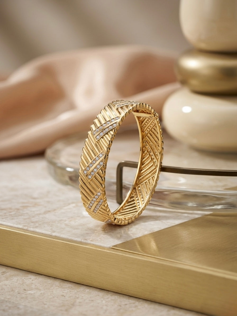 Luxury chevron textured gold diamond bangle.