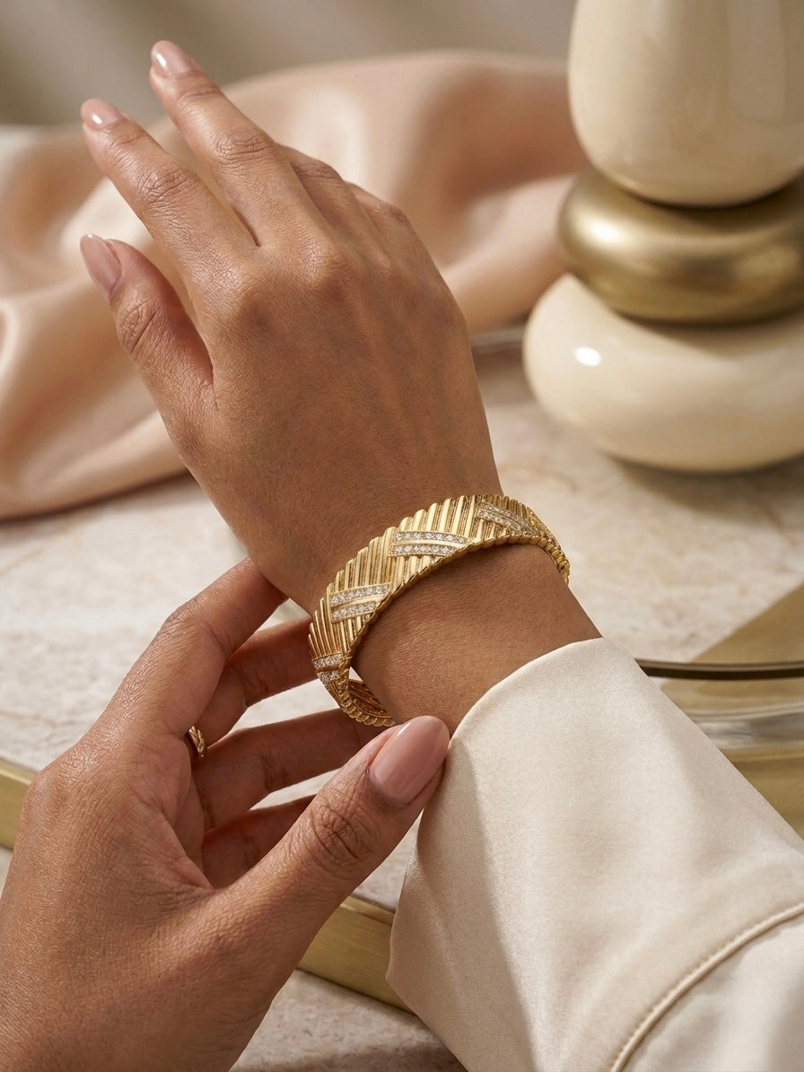 Luxury chevron textured gold diamond bangle.
