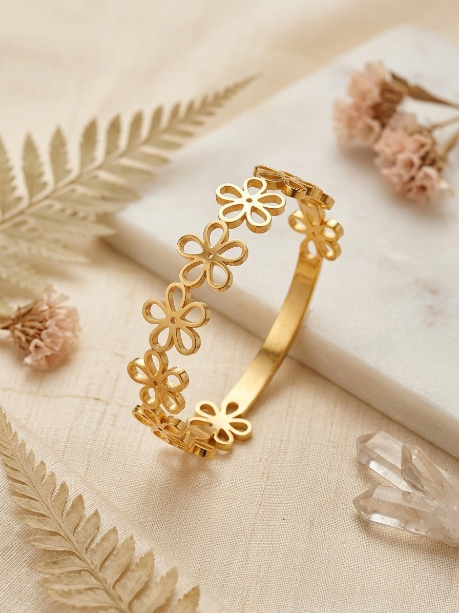 Elegant gold-toned cutout floral bangle bracelet.