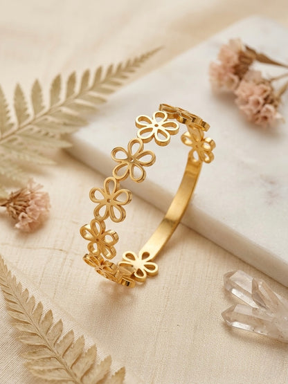 Elegant gold-toned cutout floral bangle bracelet.