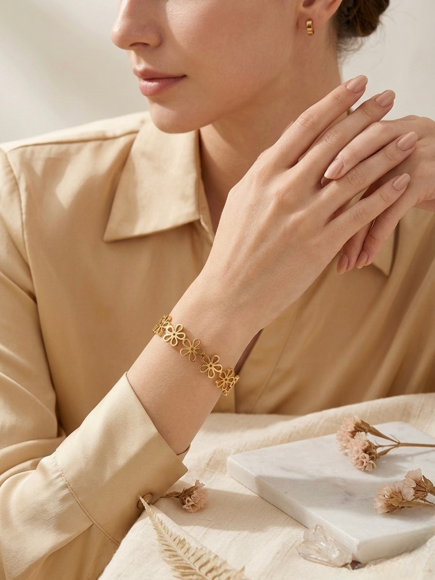 Elegant gold-toned cutout floral bangle bracelet.