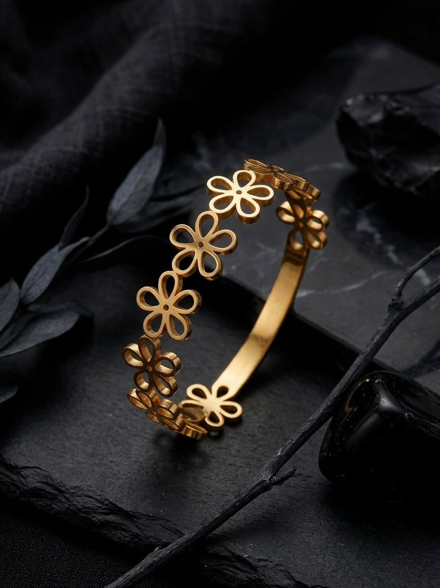 Elegant gold-toned cutout floral bangle bracelet.
