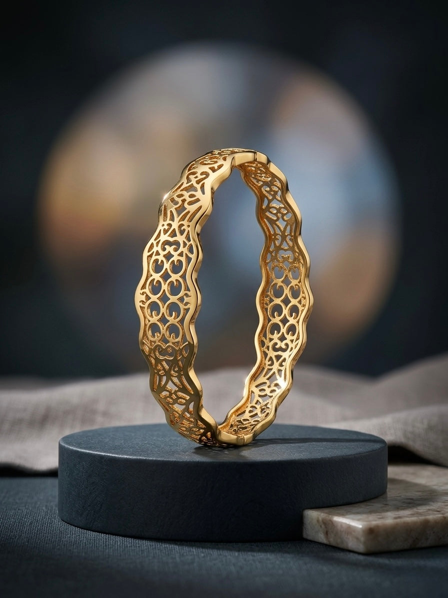 Intricate gold scalloped filigree cutout bangle.
