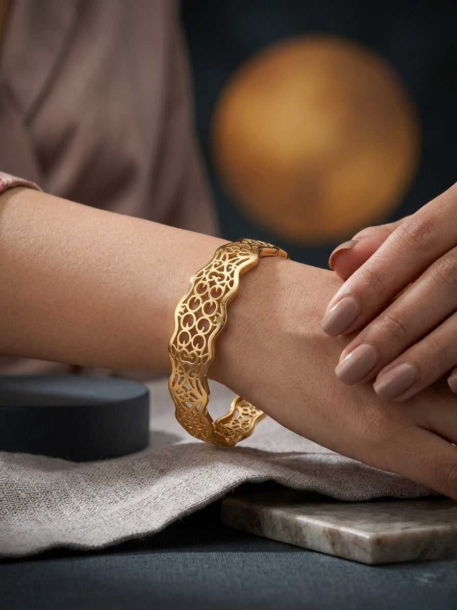 Intricate gold scalloped filigree cutout bangle.