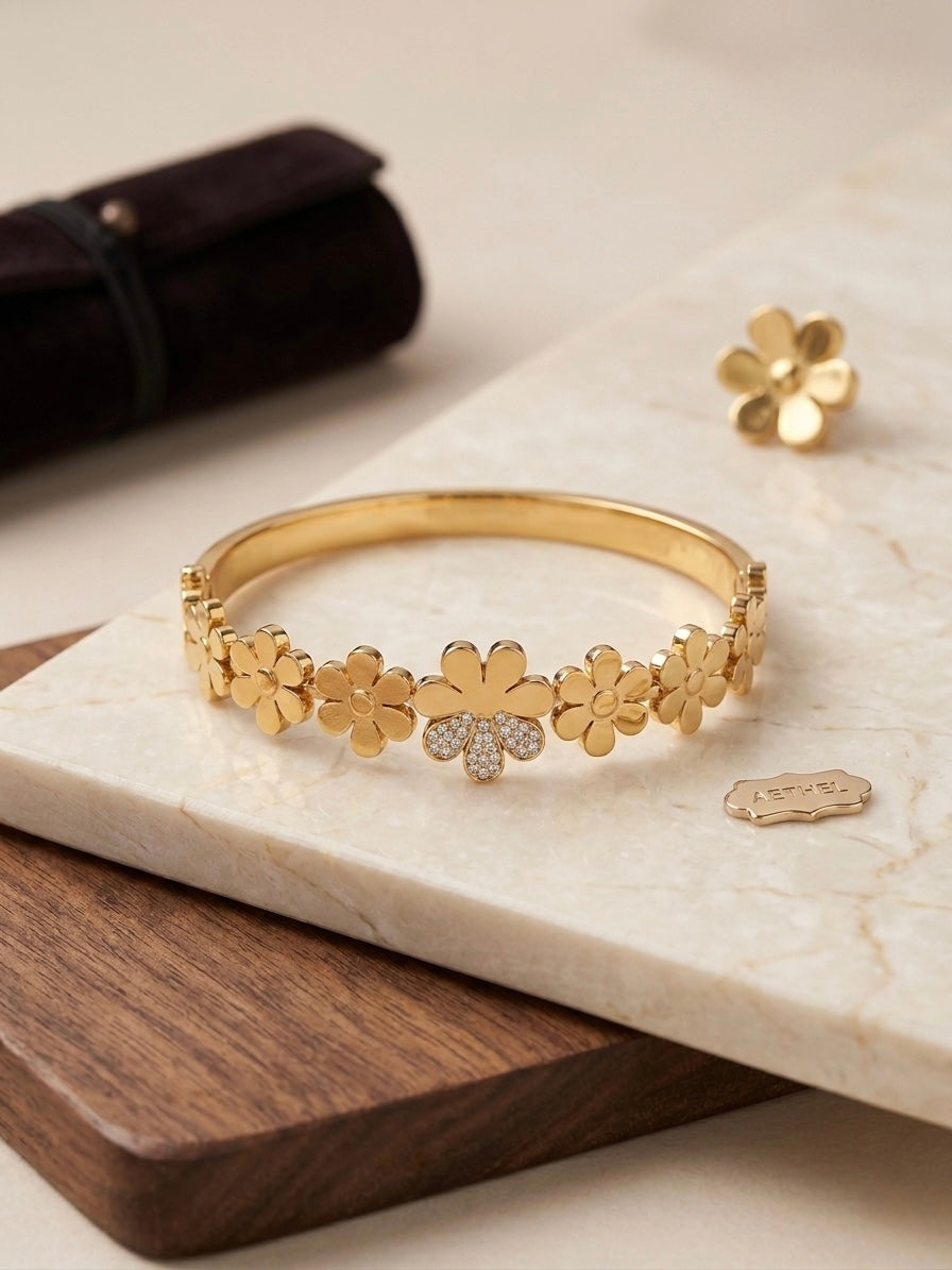 Gold floral crystal accented bangle bracelet.