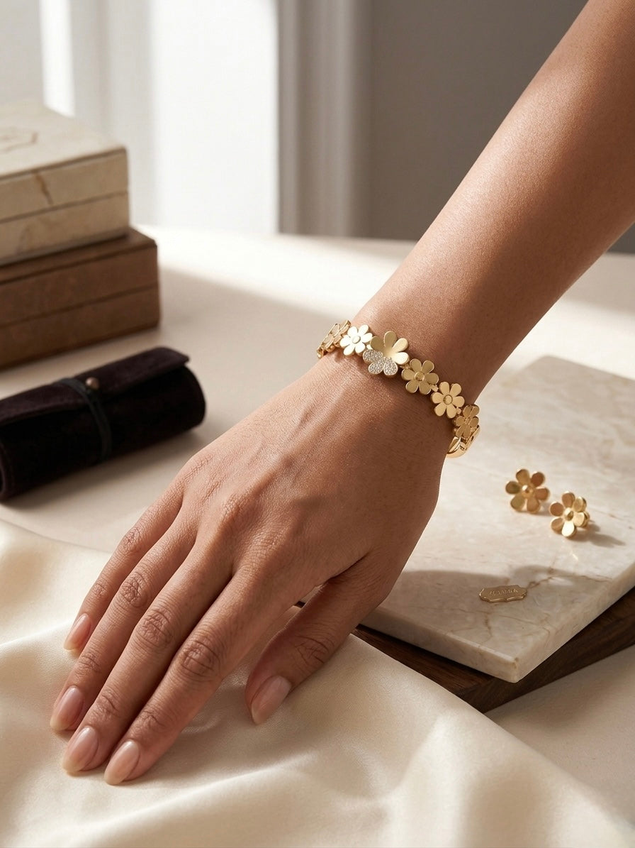 Gold floral crystal accented bangle bracelet.