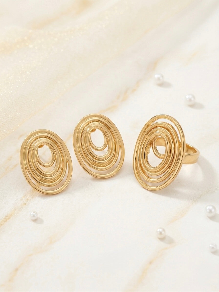 Elegant gold swirl ring and earrings.