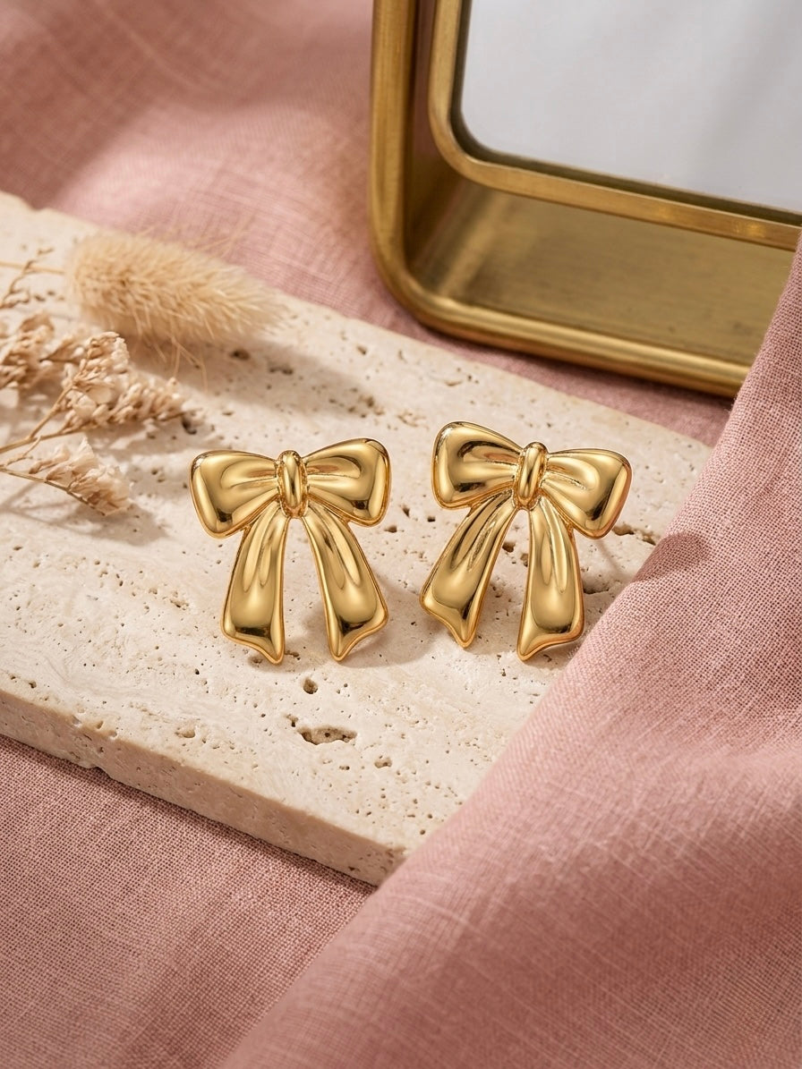 Charming gold bow stud statement earrings.