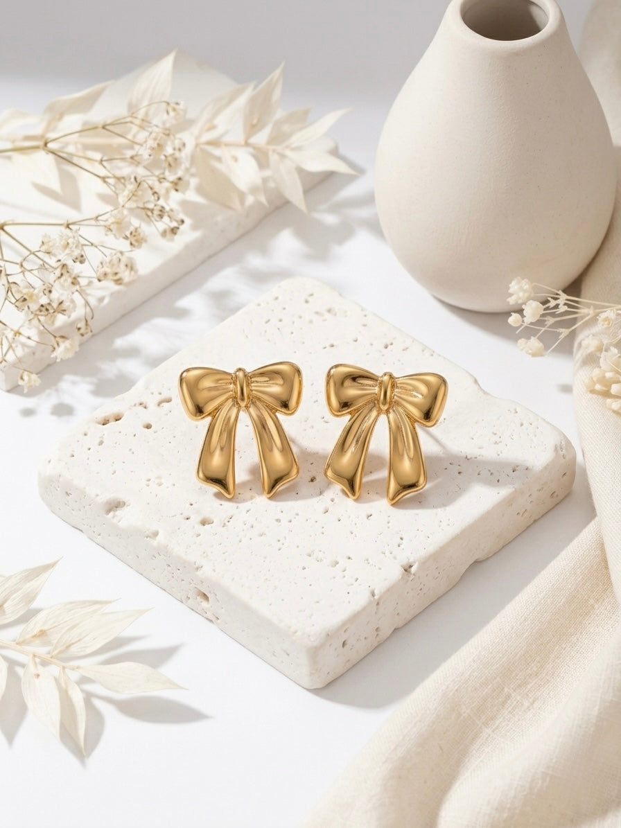 Charming gold bow stud statement earrings.