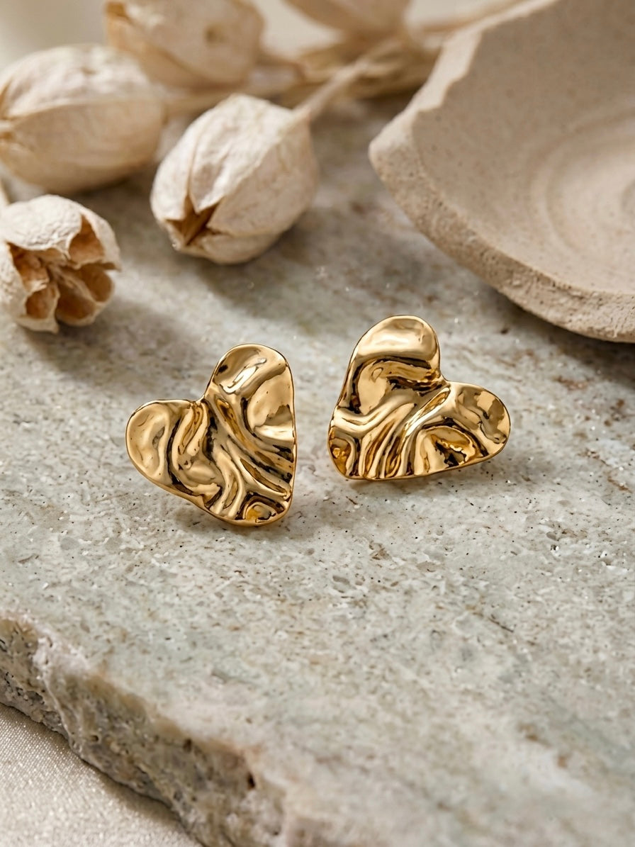 Chic crumpled gold heart statement studs.
